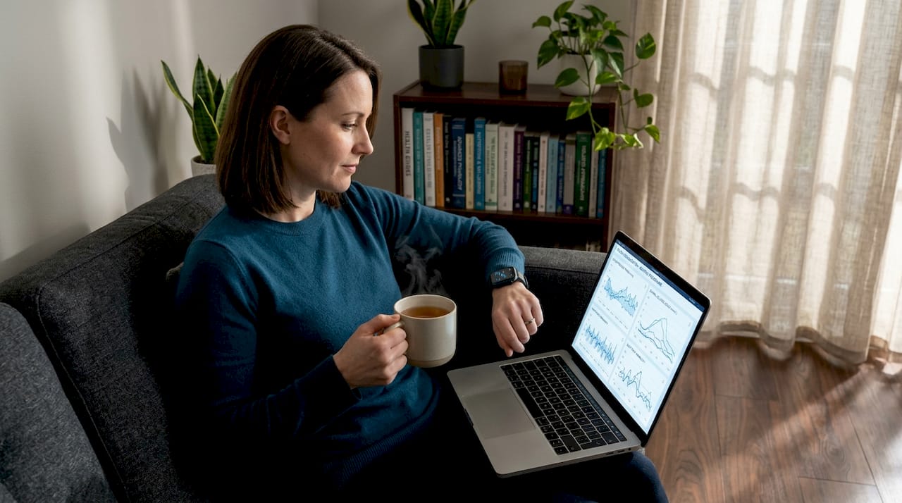 Woman tracking health data on smartwatch at home
